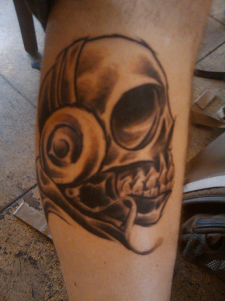 Skull and headphone tattoo by